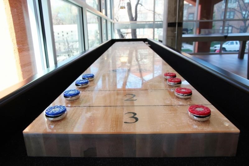 a game of shuffleboard on a wooden table