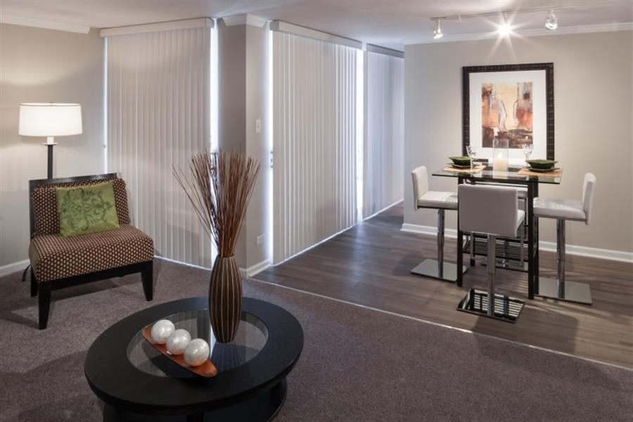 a living room and dining room with a table and chairs