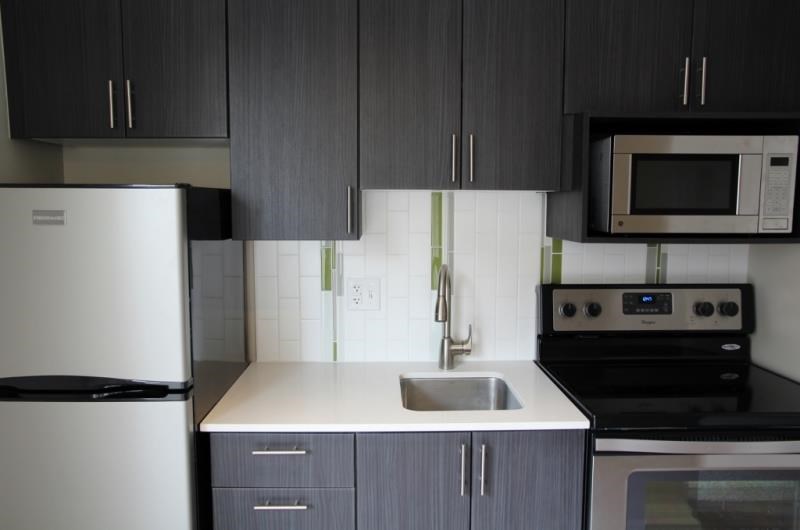 a kitchen with a sink and a refrigerator