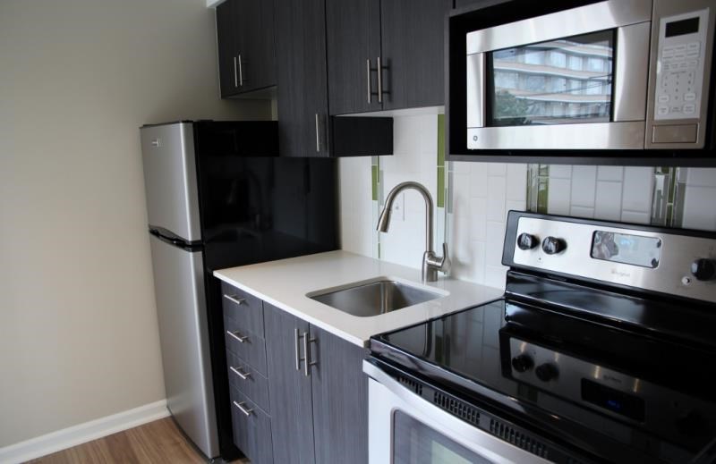 a kitchen with a stove microwave and a refrigerator