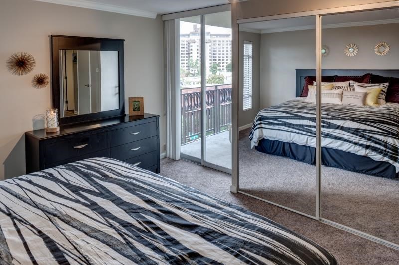 a bedroom with a bed and a mirror