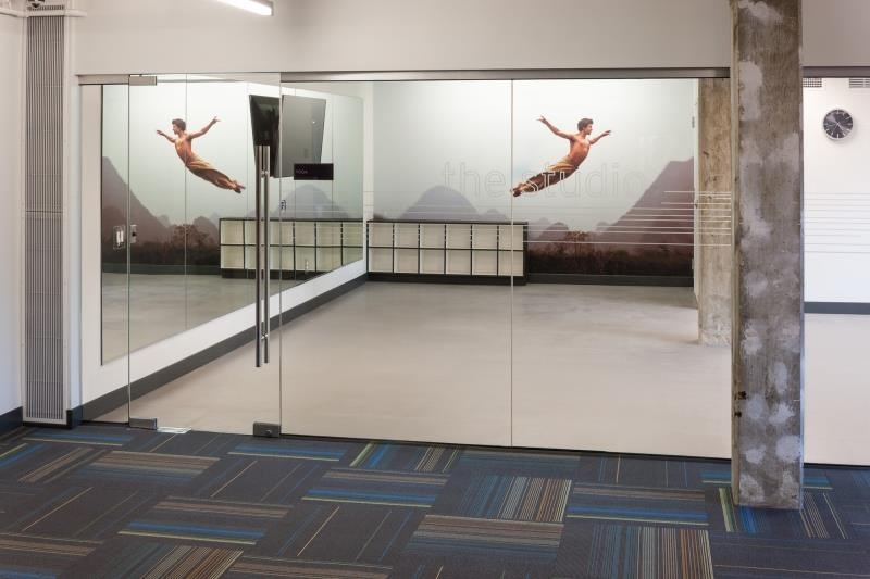 a lobby with a glass door with two men jumping in it