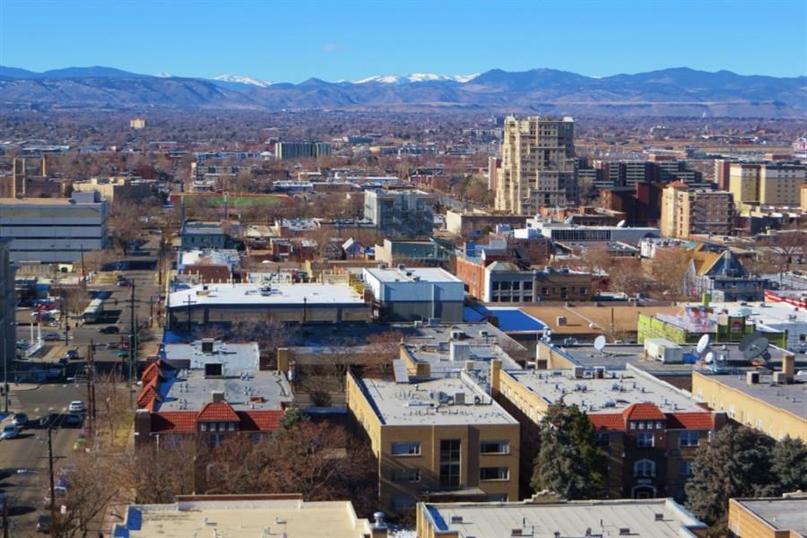 a cityscape of a city with mountains in the background