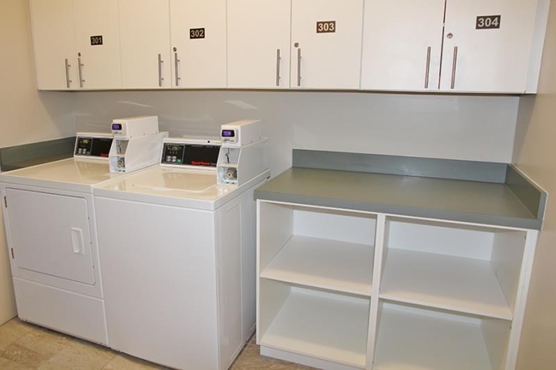 a kitchen with white appliances and white cabinets