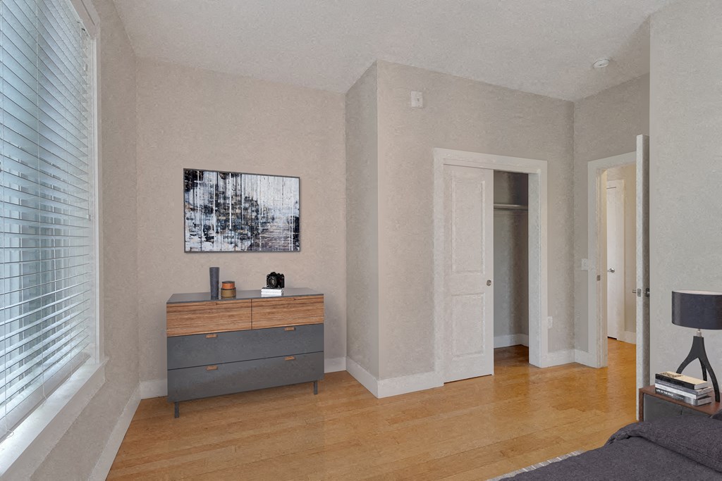 a living room with a dresser and a window