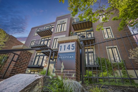 a building with a sign in front of it that reads 1145 napoleon street