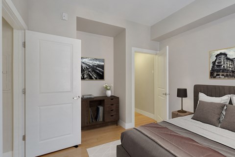 a bedroom with a large bed and a door to a closet