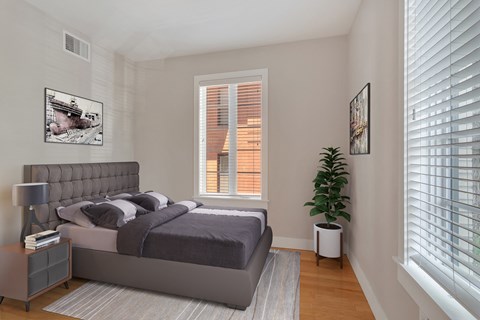 a bedroom with a bed and a large window