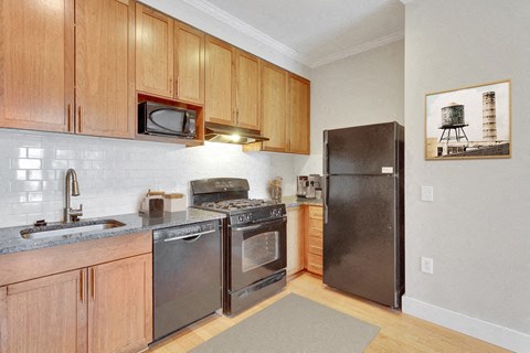 a kitchen with stainless steel appliances and wooden cabinets