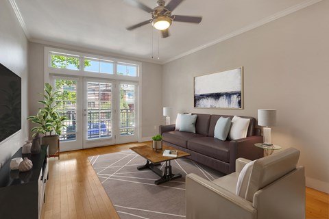 a living room with a couch and a ceiling fan
