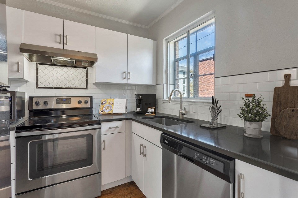 a kitchen with stainless steel appliances and white cabinets
