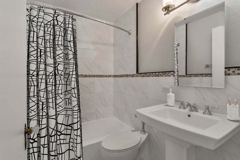 a bathroom with a shower curtain and a sink
