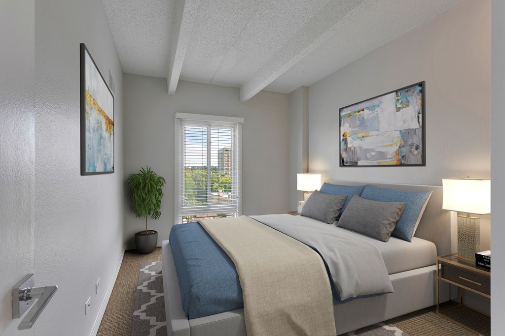 A bedroom with a large bed and two framed pictures on the wall.