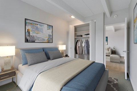 A bedroom with a large bed and a painting on the wall.