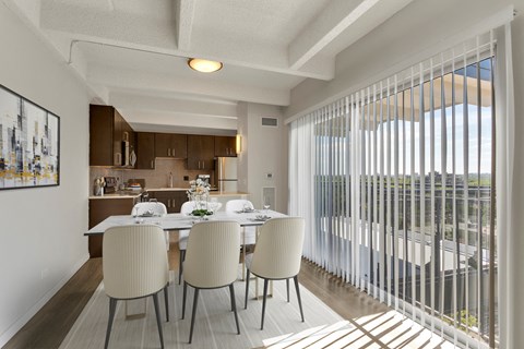 A dining room with a table set for four.