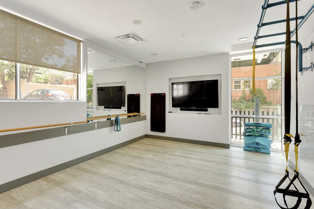 a living room with a tv and a ladder on the wall