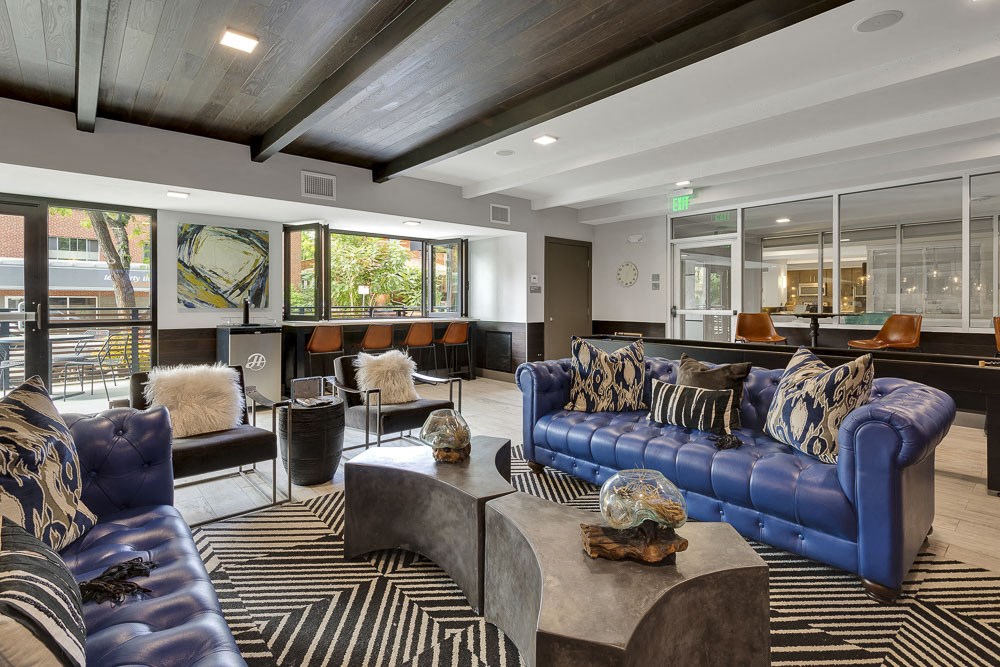 a living room with couches and chairs and a bar
