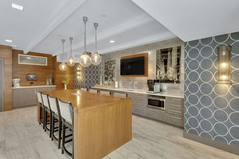 a kitchen with a large island and a table with chairs
