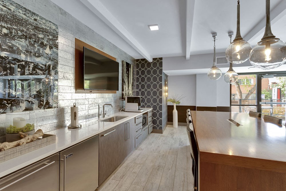 a kitchen with a long counter top and a sink
