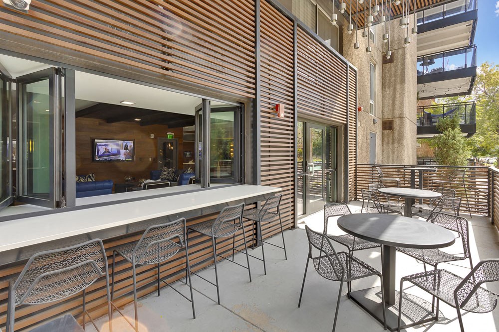 a patio with tables and chairs outside of a building