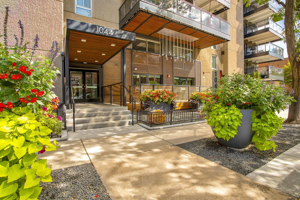 the entrance to a building with potted plants