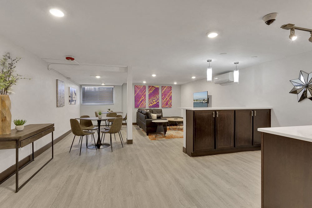 a living room and dining room with a table and chairs