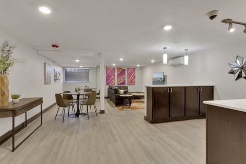 a living room and dining room with a table and chairs