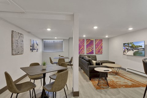 a living room with a couch and a table and chairs