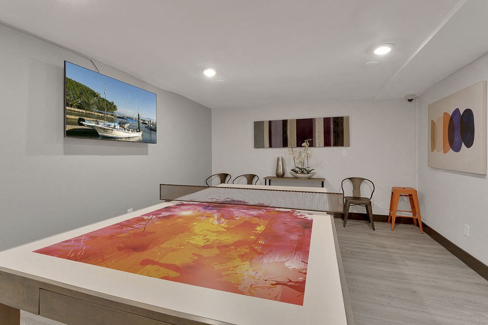 a room with a pool table and a painting