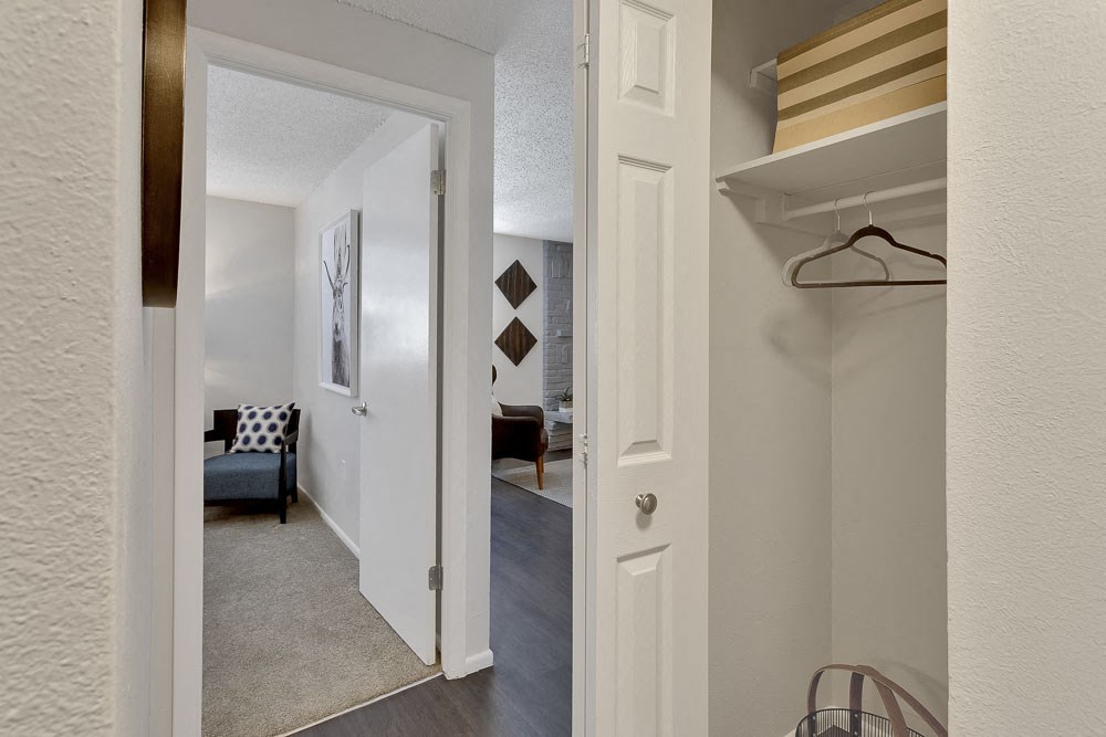 a view of a hallway with a closet and a living room
