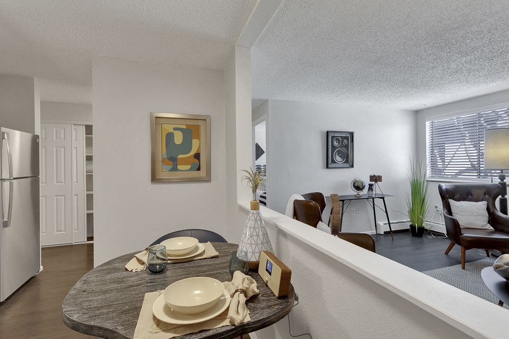 an open living room and dining room with a table with plates on it