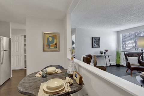 an open living room and dining room with a table with plates on it