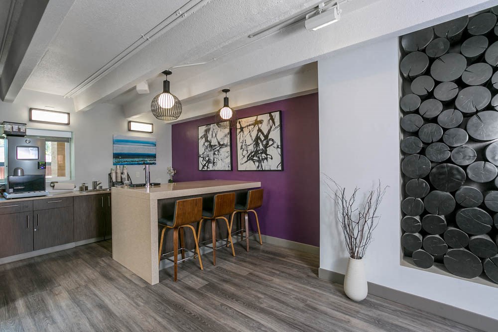 a bar in a room with a counter and chairs