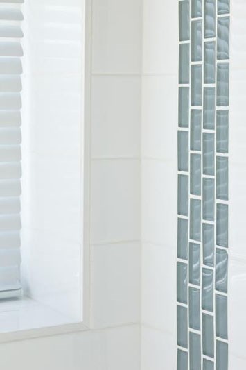 a bathroom with a shower curtain and a mirror