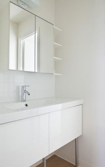 a white bathroom with a sink and a mirror