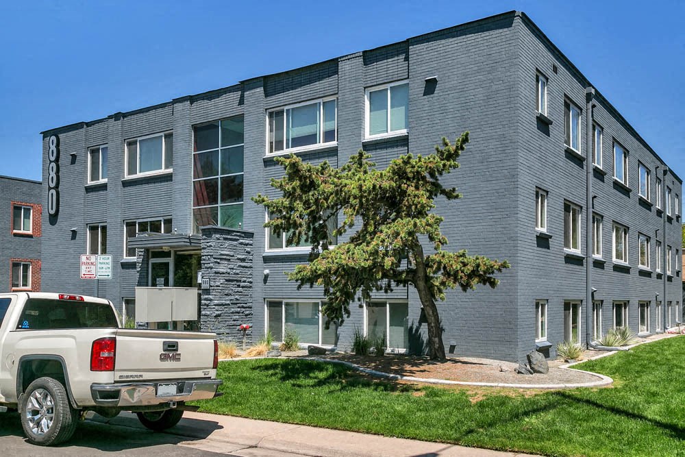 a truck parked in front of an apartment building