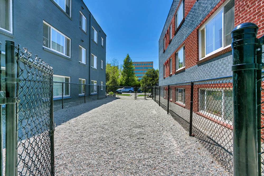 a fenced in area of a building with a chain link fence