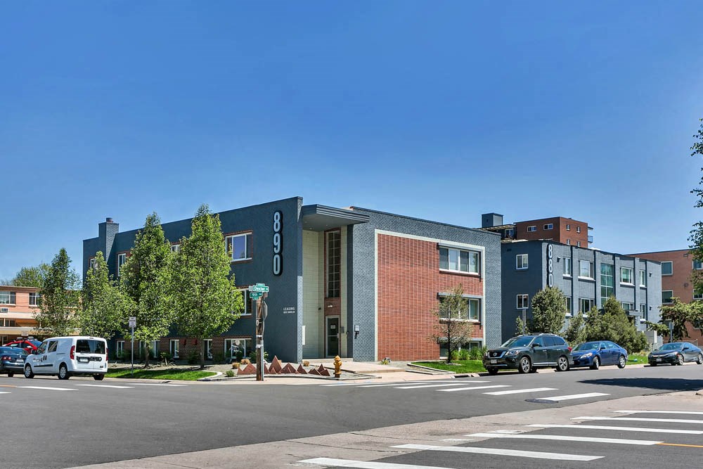 a building with cars parked in front of it on a street
