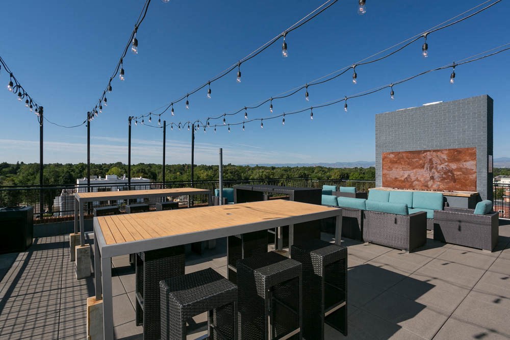 a rooftop patio with tables and chairs