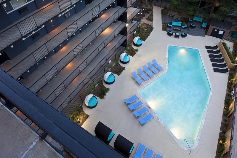 an overhead view of a swimming pool in an apartment building