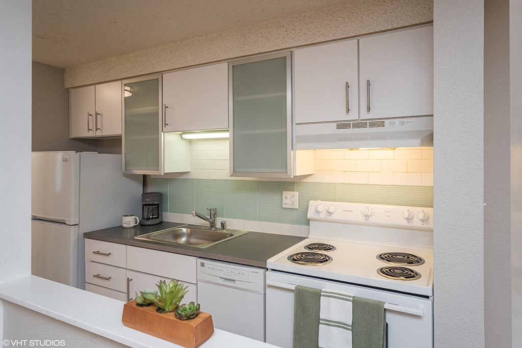 a white kitchen with white appliances and white cabinets