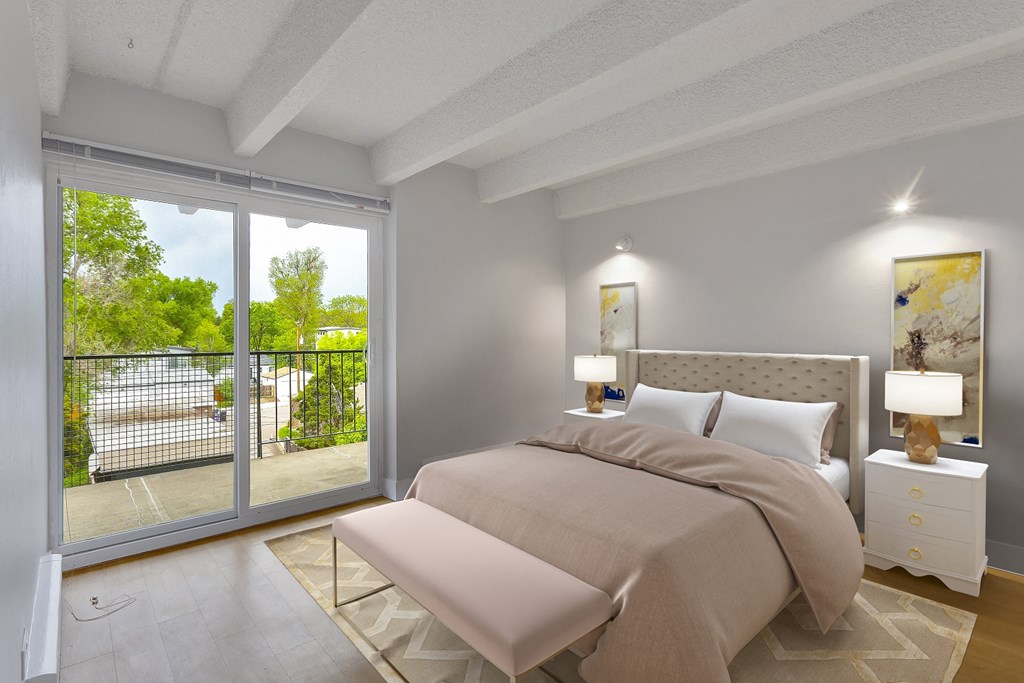 a bedroom with a bed and a sliding glass door
