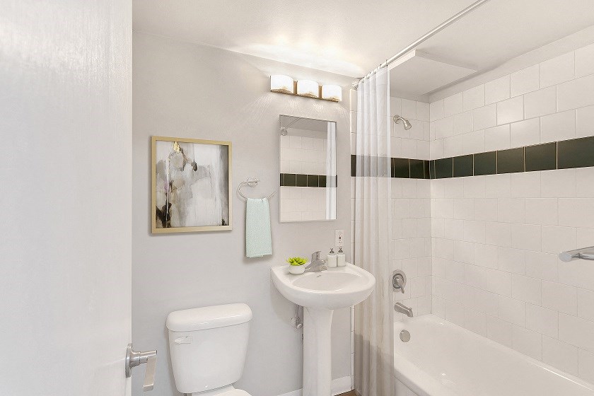 a bathroom with a toilet sink and tub and a shower