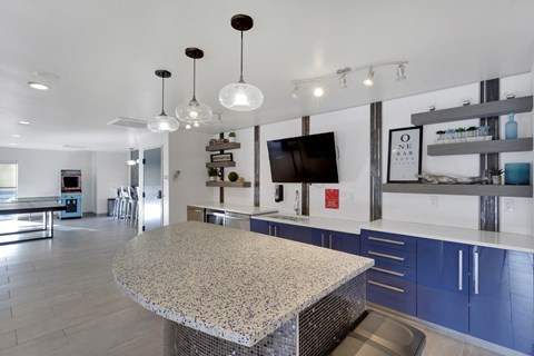 A kitchen with a granite countertop and blue cabinets.