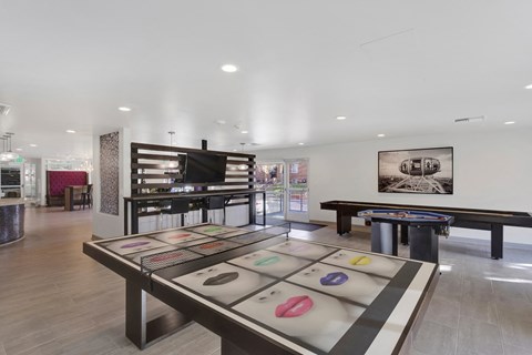 A room with a pool table and a picture on the wall.