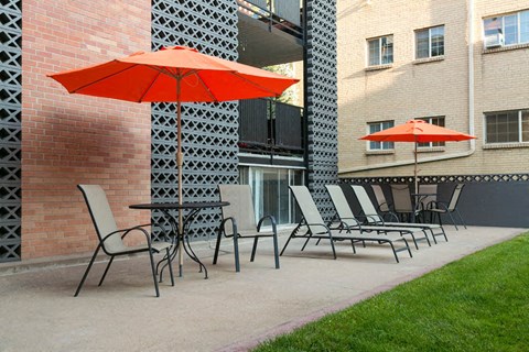 a group of chairs and umbrellas on a patio