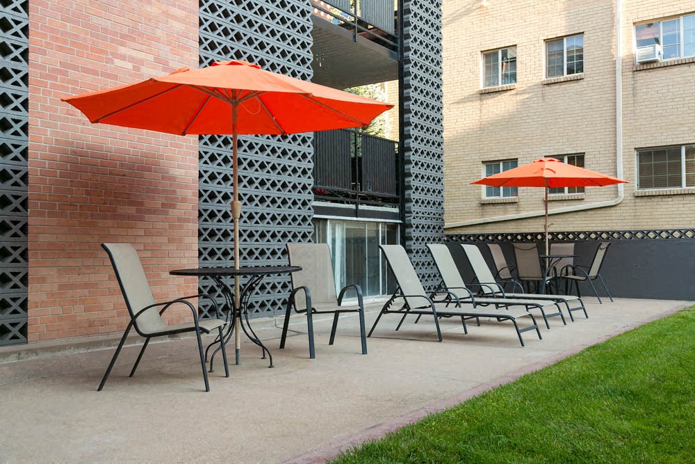 a group of chairs and umbrellas on a patio