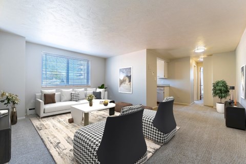 A living room with a sofa, armchairs, and a coffee table.