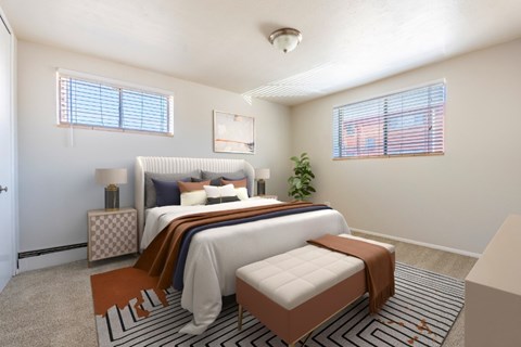 A bedroom with a large bed and a small bed in it.