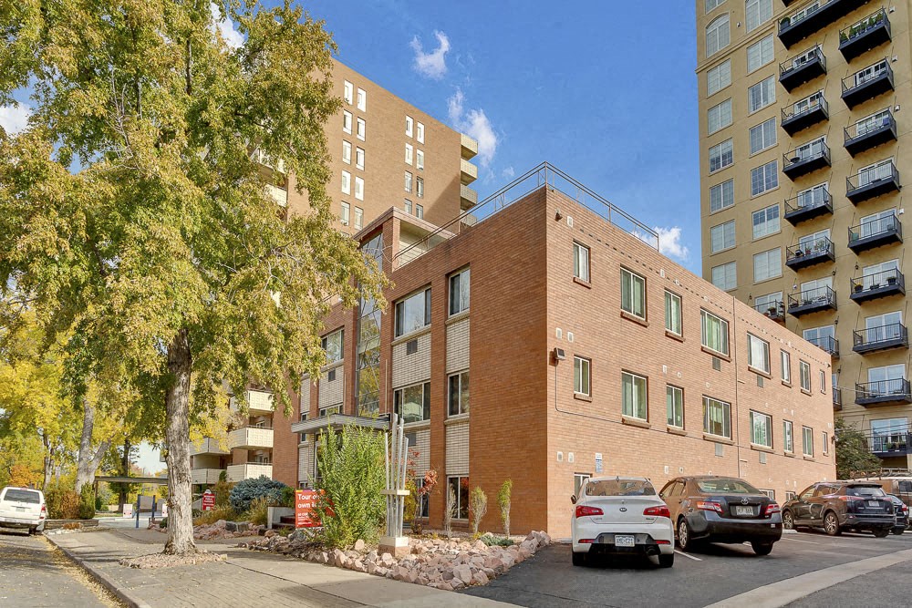 a brick building with cars parked in front of it